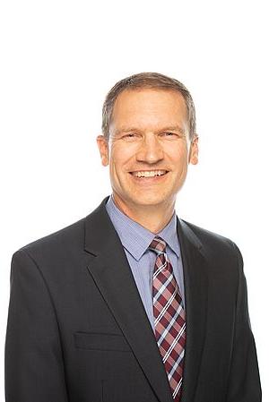 Photo of Paul Dybdahl against white background.